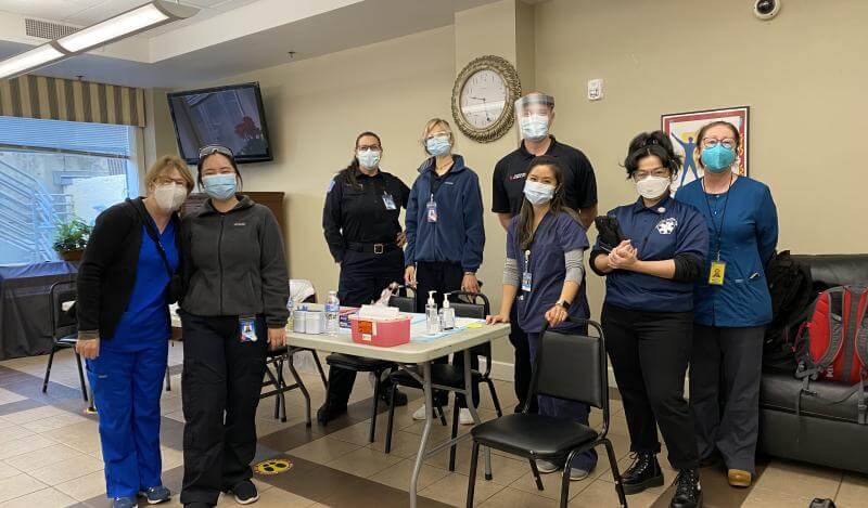 A group of staff from the Department of Public Health pose in masks