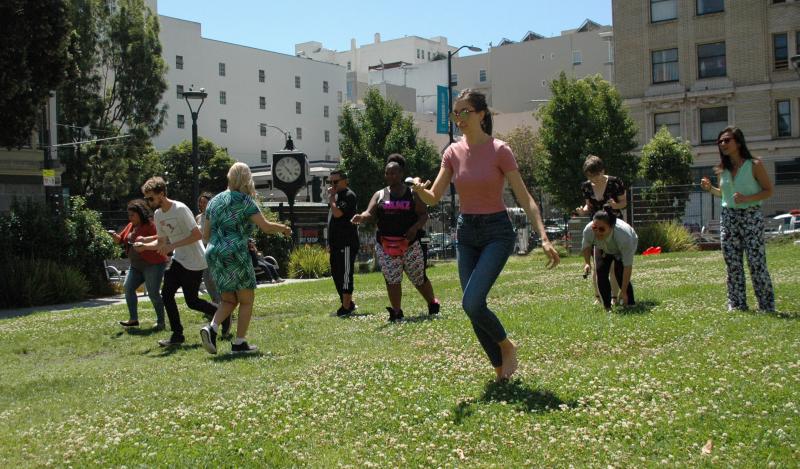 A group of staff members compete in a race in a park