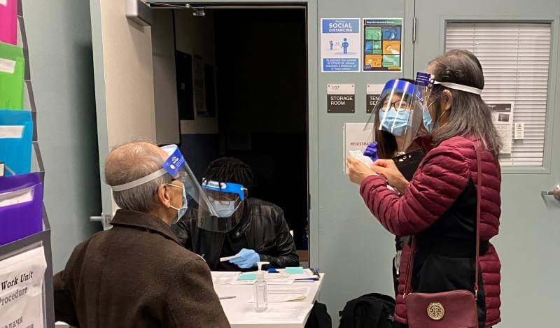 TNDC staff and tenants wear PPE as tenants register for the Covid vaccine 