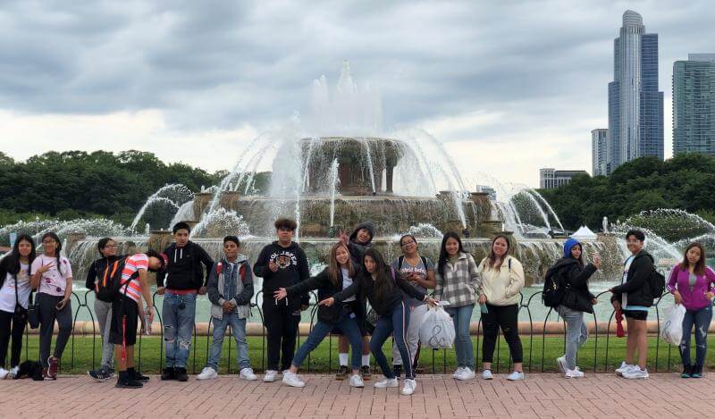 A multi-racial group of teens posing outside in Chicago