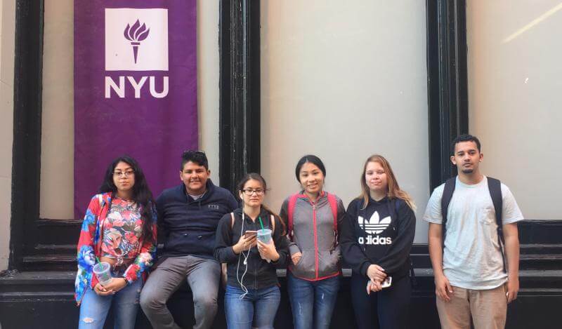 A multi-racial group of teens pose at NYU