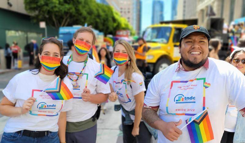 A smaller group in rainbow poses for Pride