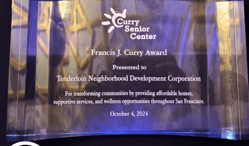 Roxanne Huey and Katie Lamont accept award from Curry Center