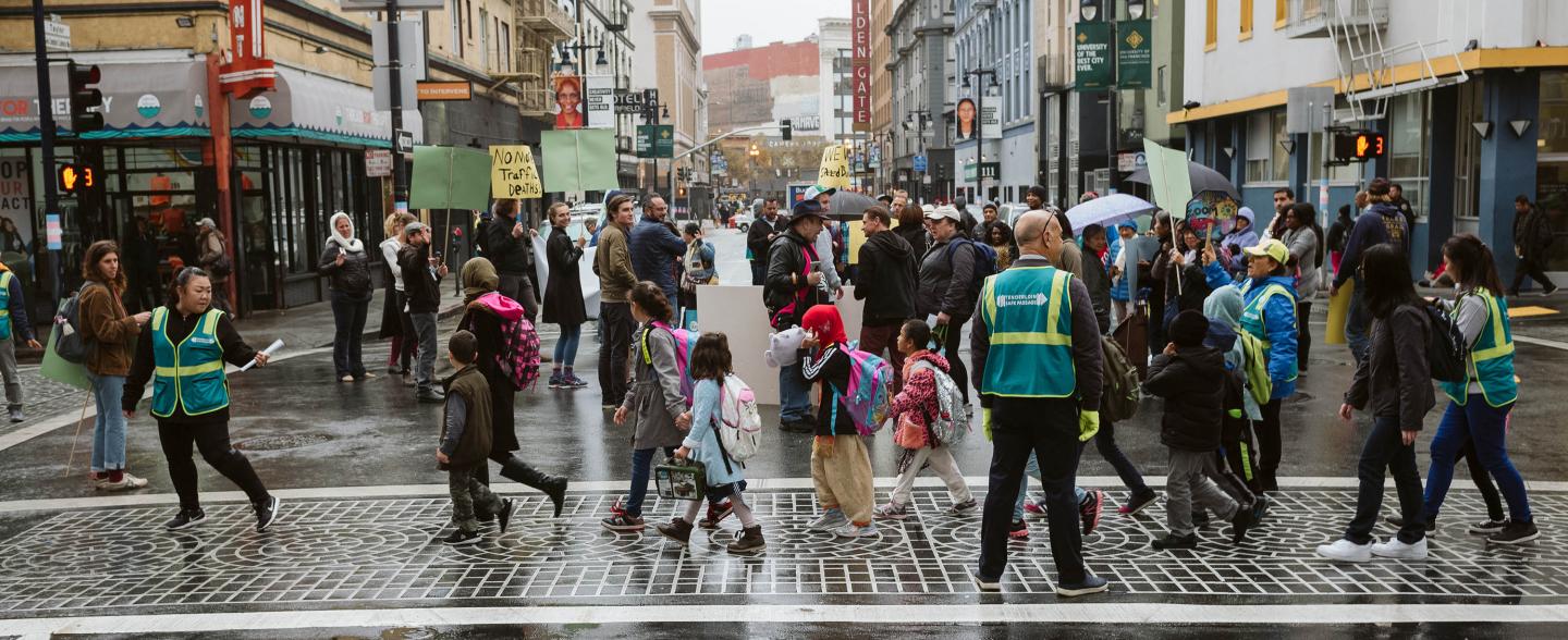 A group of people protest outside in the Tenderloin streets