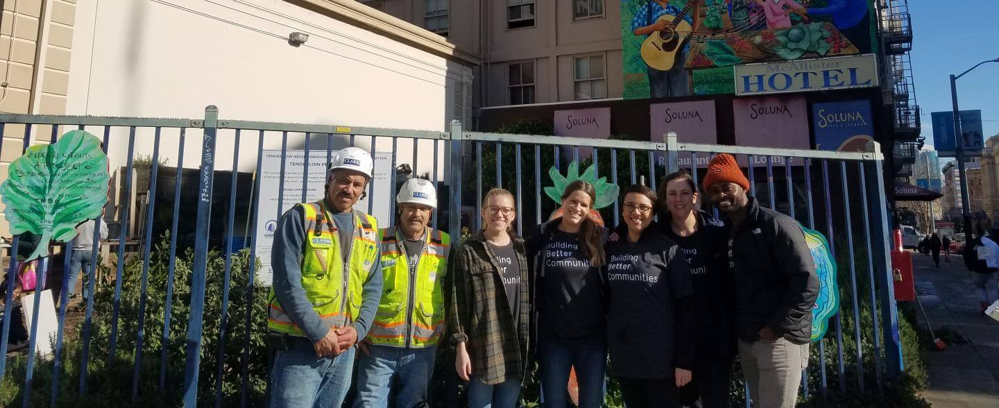 A group of volunteers from Clark Construction pose in front of the Tenderloin People's Garden