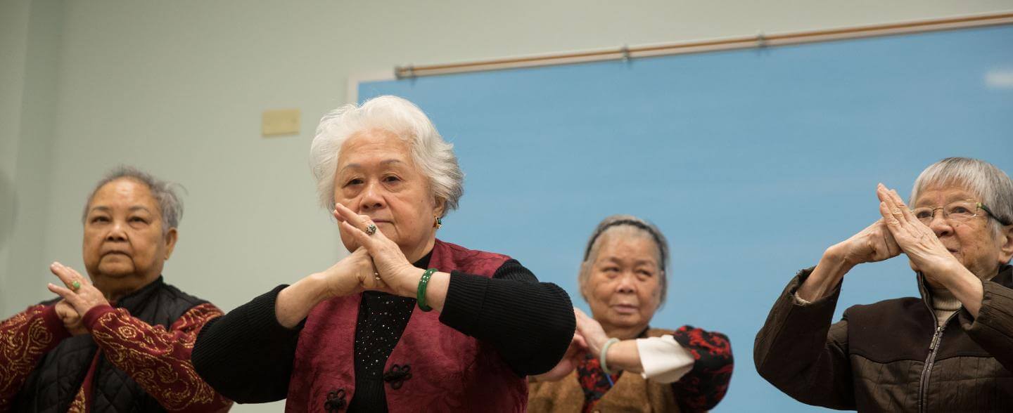 A ground of asian seniors practice tai chi