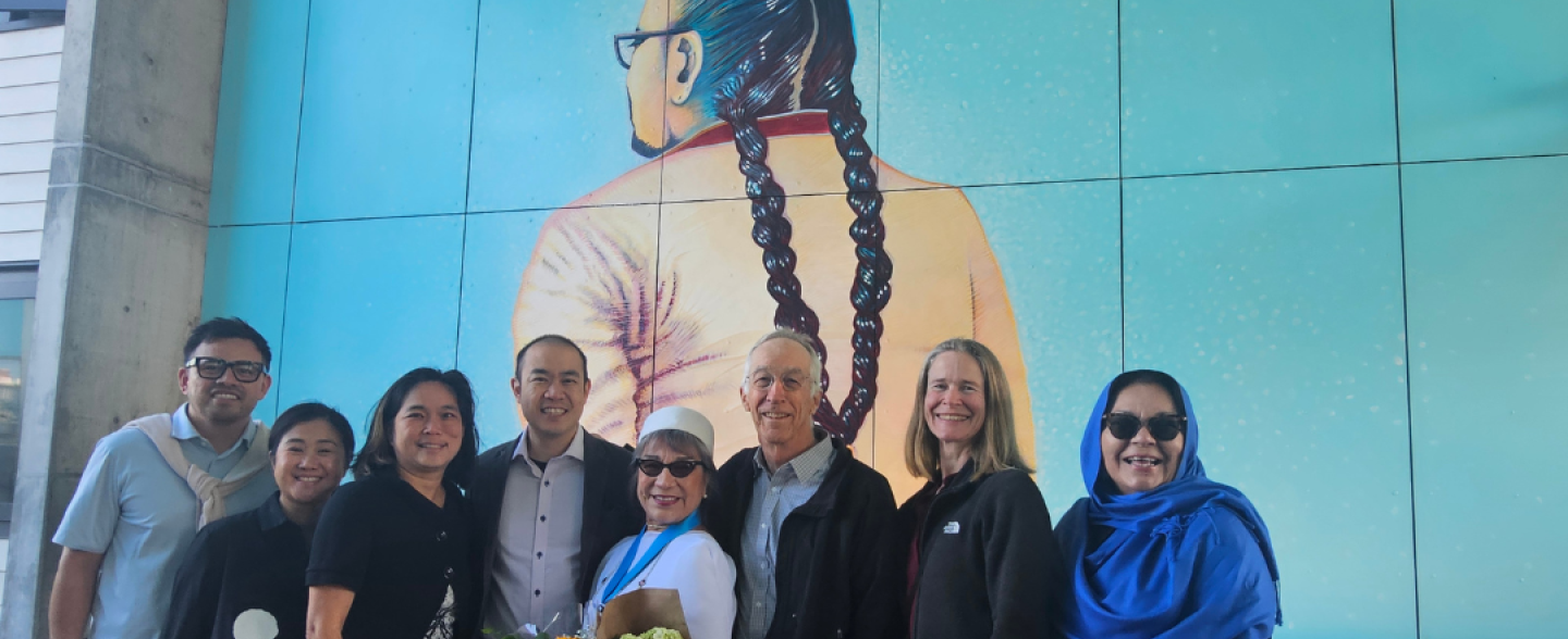 MEDASF and TNDC officials standing with Lorraine Garcia-Nakata during mural unveiling at Casa Adelante. 