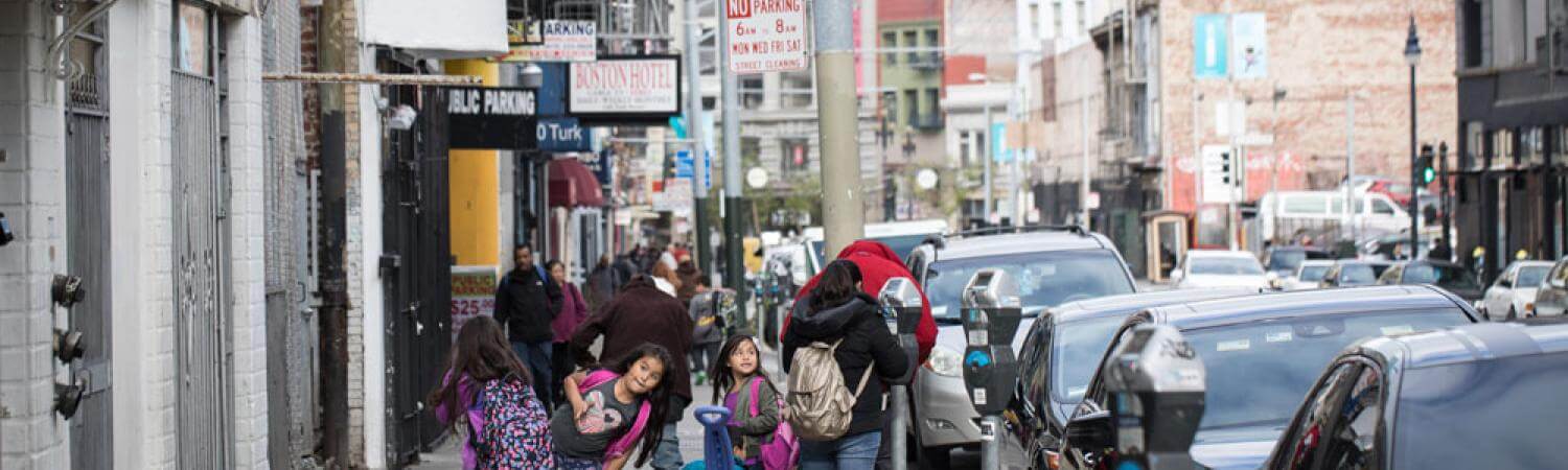 Turk street in the Tenderloin, backs of a family walking