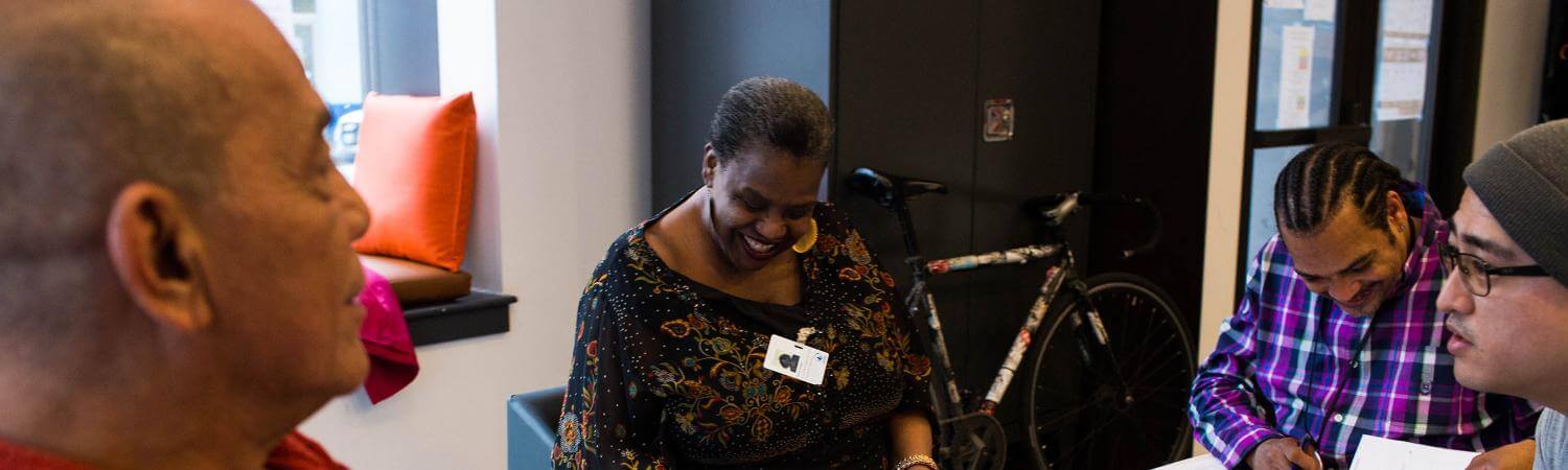A multi-racial group is laughing in a meeting 
