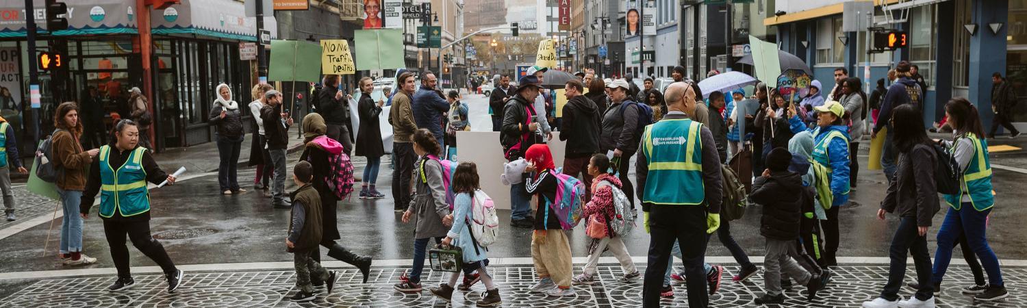 A group of people protest outside in the Tenderloin streets