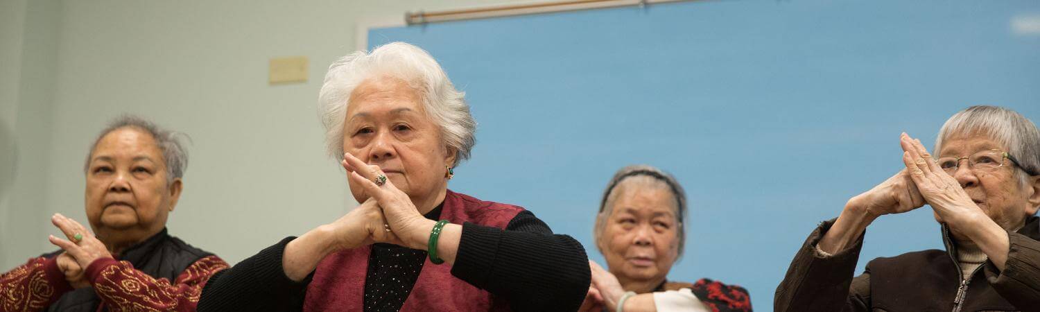 A ground of asian seniors practice tai chi