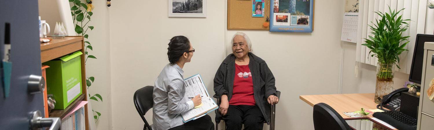 An asian social worker assists a tenant in her office