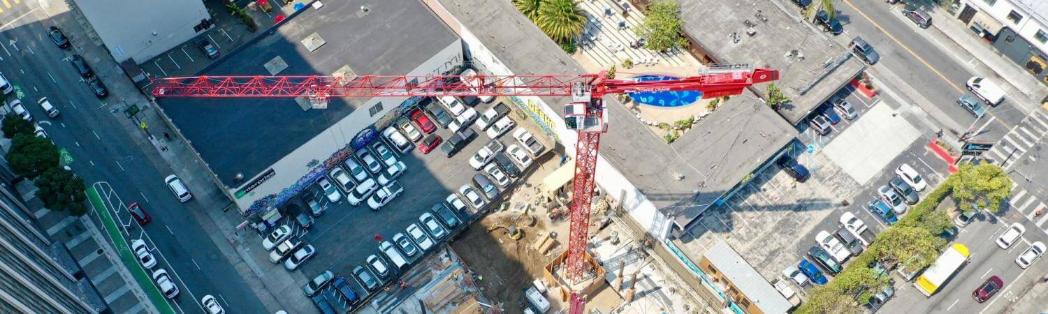 Aerial view of construction at 555 Larkin in the Tenderloin, a red crane is pictured at the center
