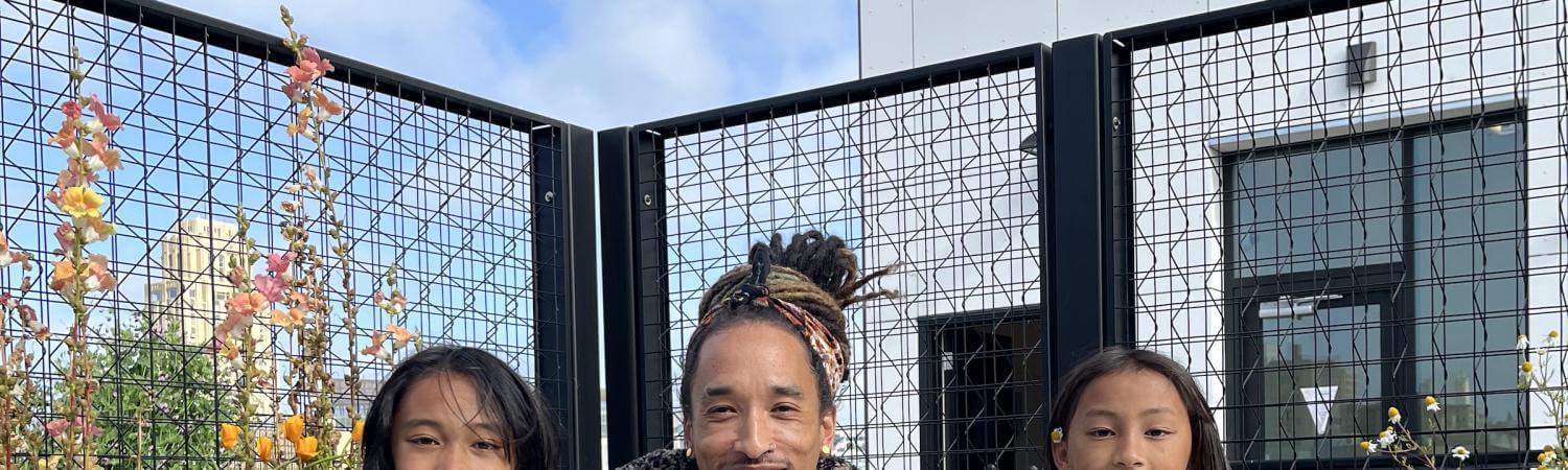 three people in a garden