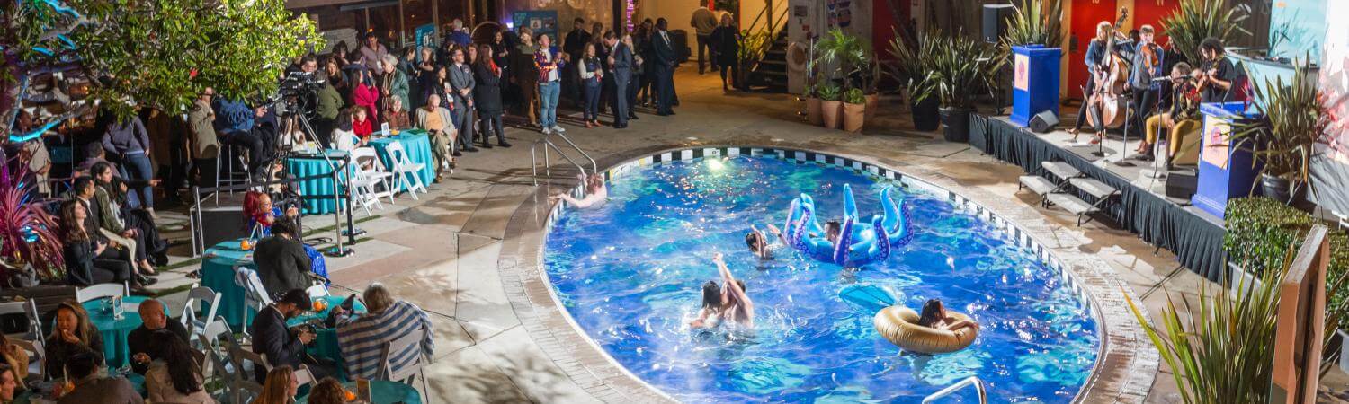 Banner of a pool with plants and people around 