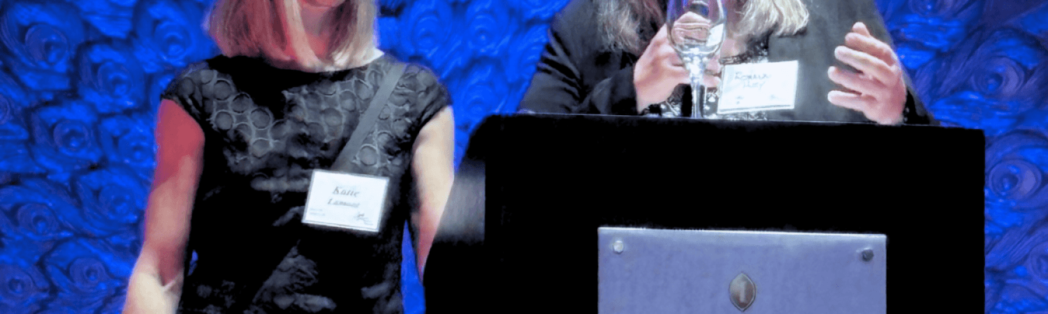 Roxanne Huey and Katie Lamont accept award from Curry Center