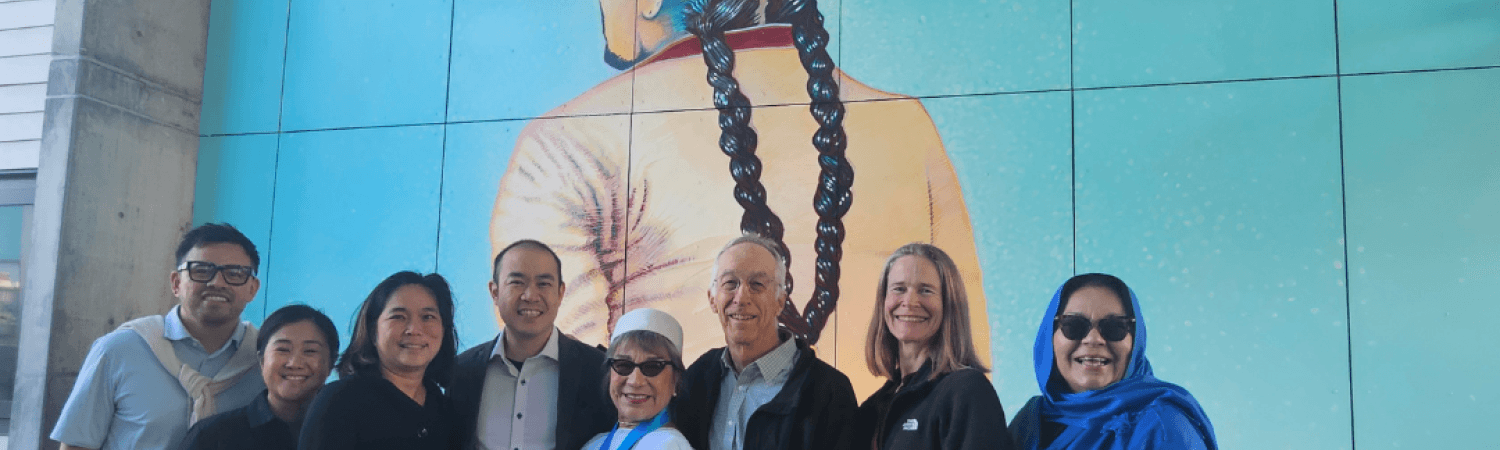 MEDASF and TNDC officials standing with Lorraine Garcia-Nakata during mural unveiling at Casa Adelante. 