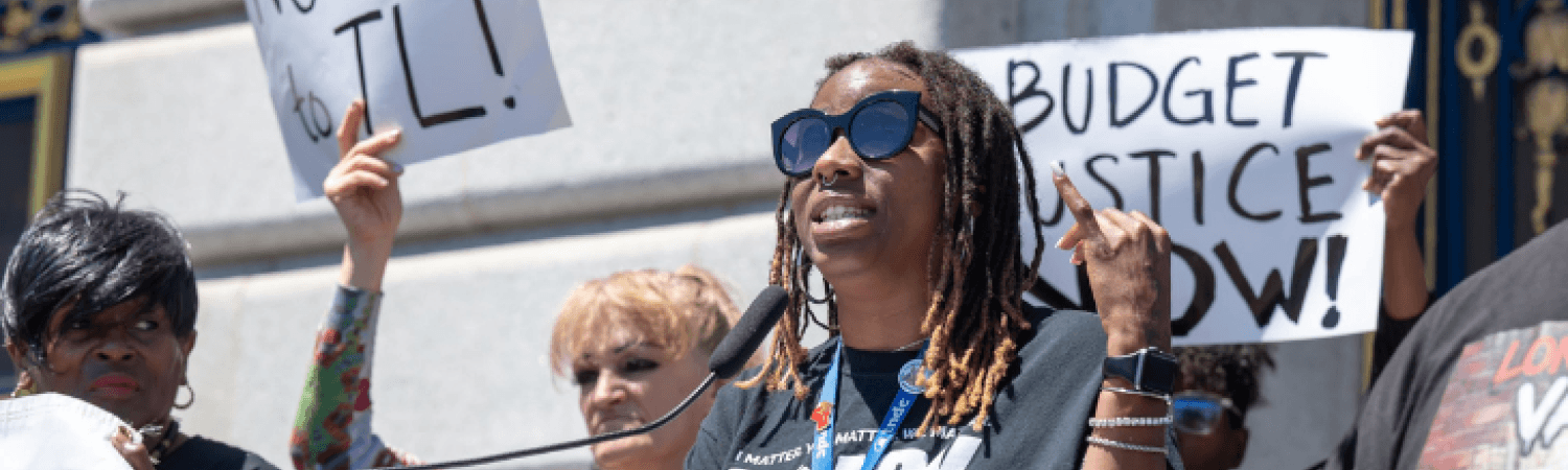Desira Brown at a podium at a protest