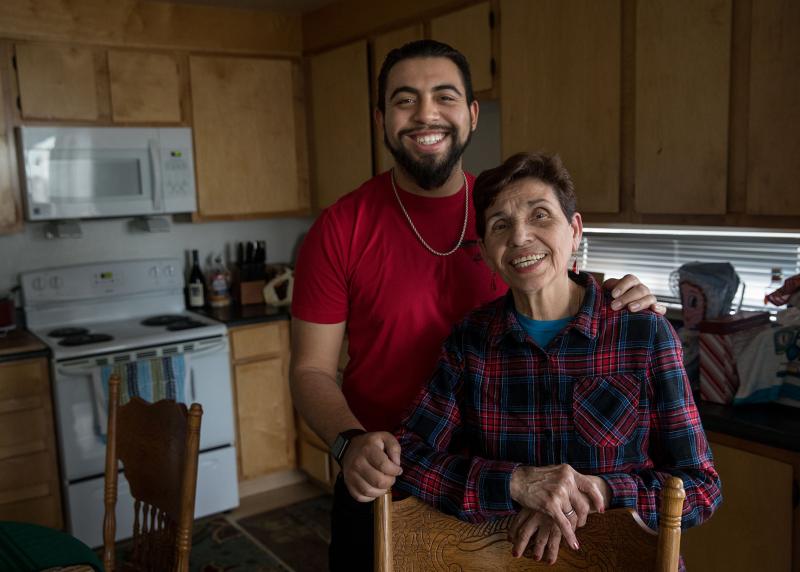 Nicaraguan Grandma and grandson pose together in kitchen