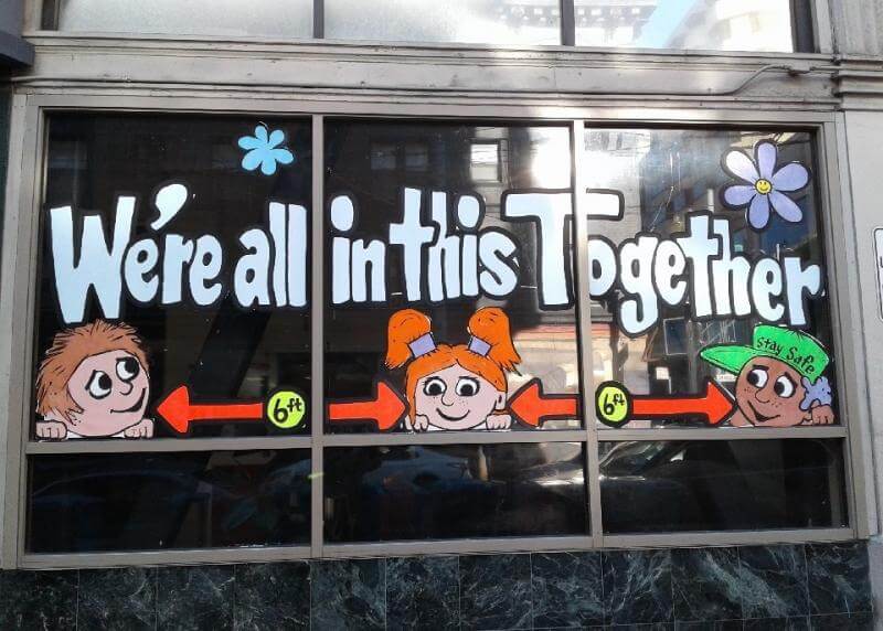"we're all in this together" window signage