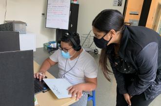 TASP staff with kid at computer