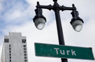 A streetlamp with a green sign reading "Turk"