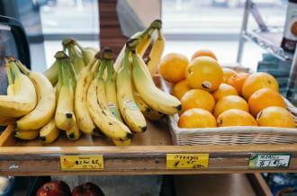 Bananas and oranges on a shelf