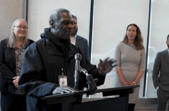 Larry Toliver speaking at 180 Jones grand opening